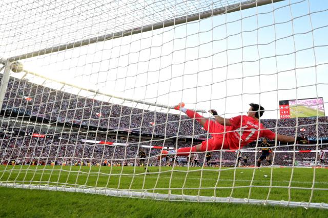 Boca Juniors' midfielder #05 Leandro Paredes takes a penalty kick and scores the opening goal past River Plate's goalkeeper #41 Santiago Beltran during the Argentine Professional Football League 2026 Apertura Tournament match between River Plate and Boca Juniors at MAS Monumental stadium in Buenos Aires on April 19, 2026. (Photo by JUAN MABROMATA / AFP)