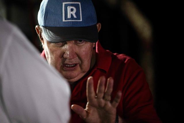 Peru's presidential candidate Rafael Lopez Aliaga waves during a protest over alleged fraud following the results of the presidential election in Lima on April 19, 2026. (Photo by ERNESTO BENAVIDES / AFP)