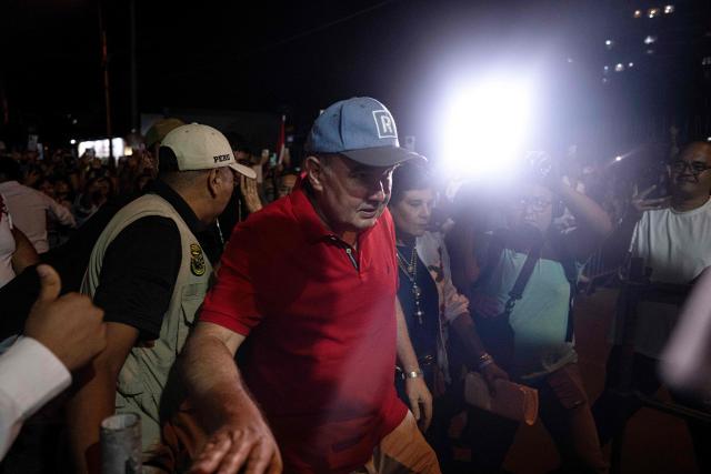 Peru's presidential candidate Rafael Lopez Aliaga arrives to a protest over alleged fraud following the results of the presidential election in Lima on April 19, 2026. (Photo by ERNESTO BENAVIDES / AFP)