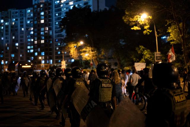 Peruvian police officers patrol during a protest called by supporters of Peru's presidential candidate Rafael Lopez Aliaga over alleged fraud following the results of the presidential election in Lima on April 19, 2026. (Photo by ERNESTO BENAVIDES / AFP)