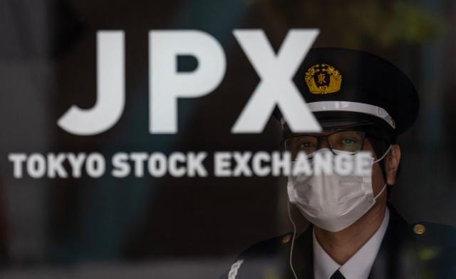 A security guard looks out from the Tokyo Stock Exchange in Tokyo on April 20, 2026. (Photo by Andrew CABALLERO-REYNOLDS / AFP)