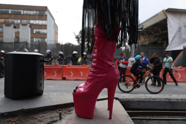 A transgender sex worker stands in heels during a protest against the Gran Tenochtitlan bike path and the organisation of the World Cup in Mexico City on April 19, 2026. The Gran Tenochtitlan is an infrastructure project designed to connect Banorte Stadium (formerly Azteca Stadium) with other points of interest in Mexico City, according to the local government. (Photo by LUIS CORTES / AFP)