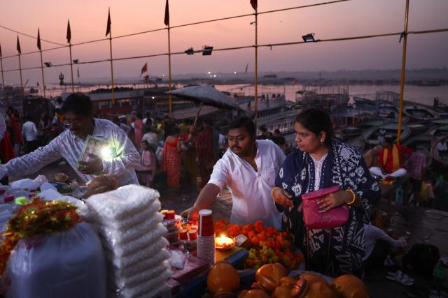 Devotees shop for religious offerings at Dashashwamedh Ghat along the banks of the river Ganges in Varanasi on April 20, 2026. (Photo by Niharika KULKARNI / AFP)