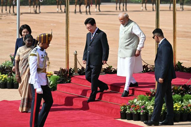 India's Prime Minister Narendra Modi (2nd R) walks with South Korea's President Lee Jae Myung (C) during a ceremonial reception at India's presidential palace Rashtrapati Bhavan in New Delhi on April 20, 2026. (Photo by Sajjad HUSSAIN / AFP)