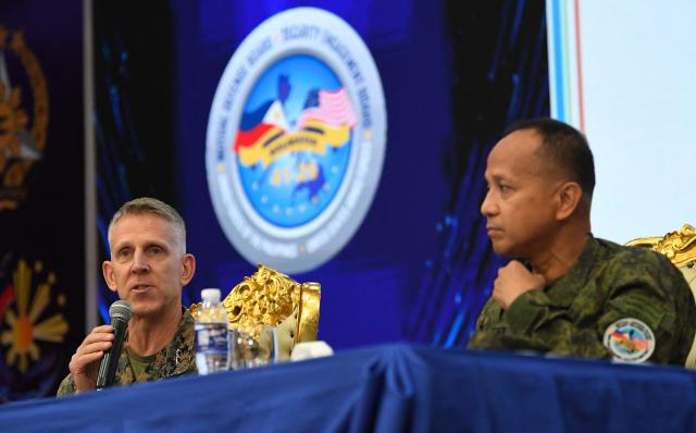 US Lieutenant General Christian Wortman (L) Commanding General I Marine Expedetionary Force, speaks next to Major General Francisco Lorenzo (R), Philippine exercise director at a press conference during the opening ceremony of the annual Balikatan (shoulder to shoulder) joint military exercise at Camp Aguinaldo in Quezon city, suburban Manila on April 20, 2026. Thousands of American and Philippine troops, joined for the first time by a significant contingent of Japanese forces, began annual military exercises on April 20 set against the backdrop of the Middle East war. (Photo by Ted ALJIBE / AFP)
