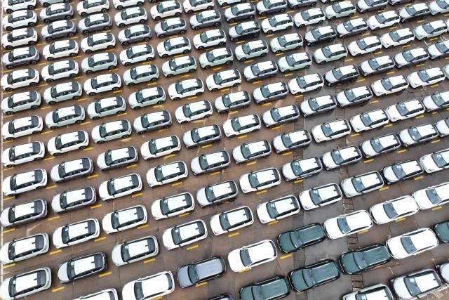 Chinese-made cars from brands including MG are seen before being loaded onto ships for export at the Dongfang Port Company terminal in Lianyungang, in China’s eastern Jiangsu province on April 20, 2026. (Photo by CN-STR / AFP) / China OUT