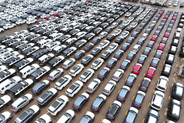 Chinese-made cars from brands including Chery and Jetour are seen before being loaded onto ships for export at the Dongfang Port Company terminal oin Lianyungang, in China’s eastern Jiangsu province on April 20, 2026. (Photo by CN-STR / AFP) / China OUT