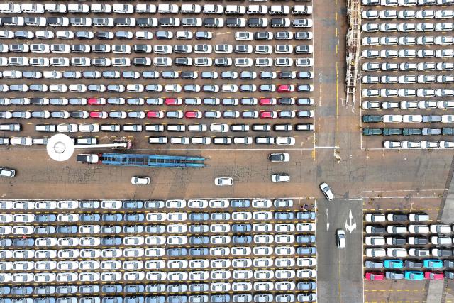 Chinese-made cars are seen before being loaded onto ships for export at the Dongfang Port Company terminal in Lianyungang, in China’s eastern Jiangsu province on April 20, 2026. (Photo by CN-STR / AFP) / China OUT