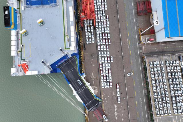 Chinese-made cars are seen before being loaded onto ships for export at the Dongfang Port Company terminal in Lianyungang, in China’s eastern Jiangsu province on April 20, 2026. (Photo by CN-STR / AFP) / China OUT