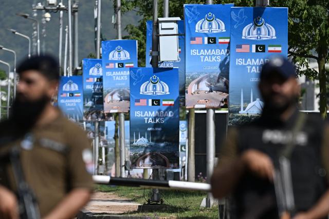 TOPSHOT - Security personnel stand guard at a security checkpost along a road temporarily closed near the Serena Hotel at the Red Zone area in Islamabad on April 20, 2026, ahead of anticipated US-Iran peace talks. Iran is not currently planning to attend talks with the United States, state media said, after President Donald Trump ordered US negotiators to travel to Pakistan on April 20, just days before a ceasefire in the Middle East expires. (Photo by Aamir QURESHI / AFP)
