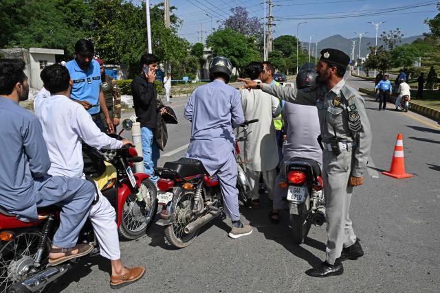 Security personnel divert motorists from a temporarily closed street leading to the Serena Hotel at the Red Zone area in Islamabad on April 20, 2026, ahead of anticipated US-Iran peace talks. Iran is not currently planning to attend talks with the United States, state media said, after President Donald Trump ordered US negotiators to travel to Pakistan on April 20, just days before a ceasefire in the Middle East expires. (Photo by Aamir QURESHI / AFP)
