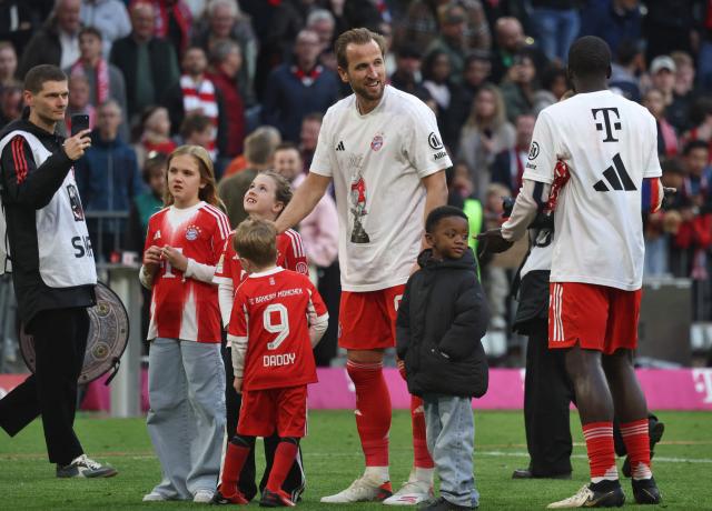 Bayern Munich's English forward #09 Harry Kane (4thL) with his children and Bayern Munich's French defender #02 Dayot Upamecano celebrate after winning the German first division Bundesliga football match between FC Bayern Munich and VfB Stuttgart as well as the Bundesliga title in Munich, southern Germany, on April 19, 2026. Bayern Munich cruised to a 4-2 home win over Stuttgart and claim a record-extending 35th Bundesliga title. (Photo by Karl-Josef HILDENBRAND / AFP) / DFL REGULATIONS PROHIBIT ANY USE OF PHOTOGRAPHS AS IMAGE SEQUENCES AND/OR QUASI-VIDEO