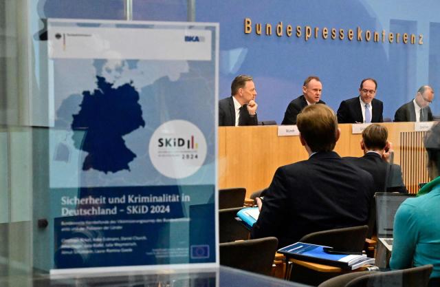 (L-R) The President of the Federal Criminal Police Office Holger Muench, Hamburg's Interior Senator Andy Grote, who is currently presiding the Conference of Germany's federal Interior Ministers, and German Interior Minister Alexander Dobrindt address a press conference to present the Federal Criminal Police Office's police crime statistics report, on April 20, 2026 in Berlin. (Photo by Tobias SCHWARZ / AFP)