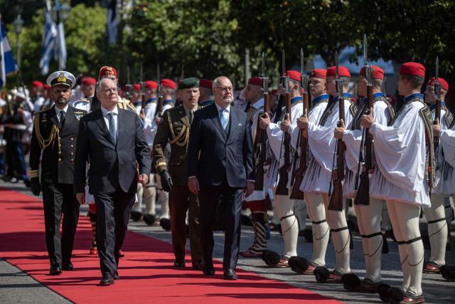 Estonia's President Alar Karis (R) and Greece's President Konstantinos Tasoulas (L) review the Presidential Guard outside the Presidential Palace prior to their meeting in Athens, on April 20, 2026. (Photo by Angelos TZORTZINIS / AFP)