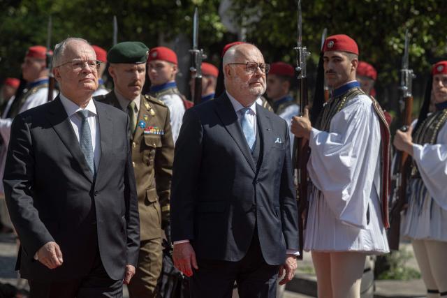 Estonia's President Alar Karis (R) and Greece's President Konstantinos Tasoulas (L) review the Presidential Guard outside the Presidential Palace prior to their meeting in Athens, on April 20, 2026. (Photo by Angelos TZORTZINIS / AFP)