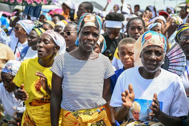 Faithfuls sing as they gather ahead of Pope Leo XIV's Holy Mass at the Saurimo esplanade in Saurimo on the eighth day of an 11-day apostolic journey to Africa, on April 20, 2026. (Photo by Alberto PIZZOLI / AFP)