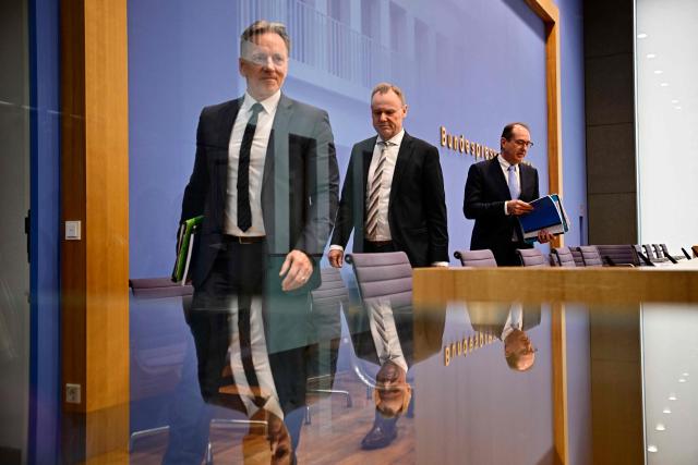 (L-R) The President of the Federal Criminal Police Office Holger Muench, Hamburg's Interior Senator Andy Grote, who is currently presiding the Conference of Germany's federal Interior Ministers, and German Interior Minister Alexander Dobrindt leave after addressing a press conference to present the Federal Criminal Police Office's police crime statistics report, on April 20, 2026 in Berlin. (Photo by Tobias SCHWARZ / AFP)