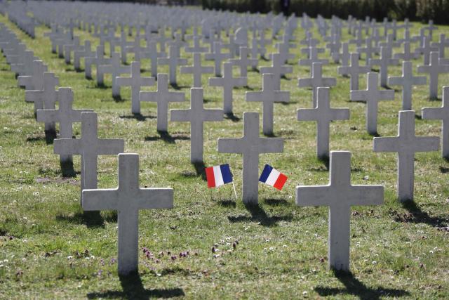An overview shows two flags with the national colors of France by a white cross at the French military cemetery in Gdansk at the start of the French President's one-day-visit to Poland, on April 20, 2026. (Photo by Ludovic MARIN / AFP)