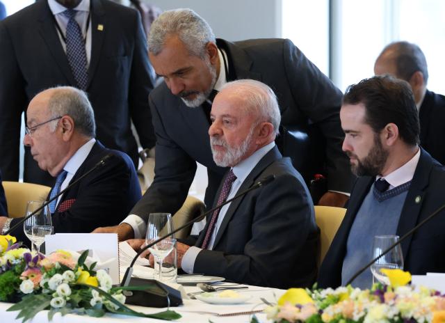 (From L) Brazil's Foreign Minister Mauro Vieira and Brazilian President Luiz Inacio Lula da Silva (C) attend the German-Brazilian governmental consultations meeting in Hanover, northern Germany on April 20, 2026, that is taking place on the sidelines of the Hannover Messe industrial trade fair. Brazil is the 2026 partner country of the fair, that will be running until April 24, 2026. (Photo by Odd ANDERSEN / AFP)