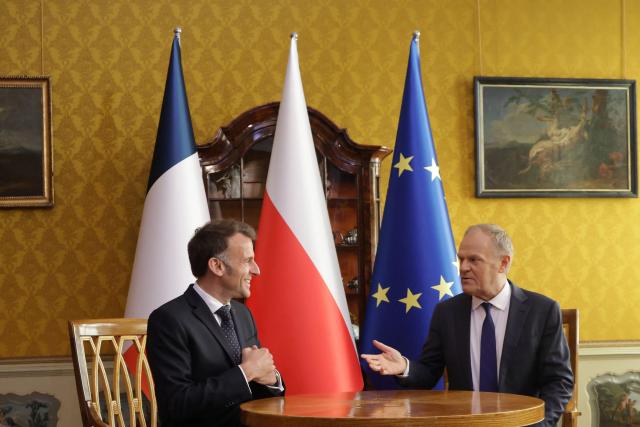 French President Emmanuel Macron (L) and Poland's Prime Minister Donald Tusk are pictuered during their meeting in the Golden Hall of the Uphagen House (Dom Uphagena) in Gdansk, Poland, on April 20, 2026, at the start of his one-day-visit to Poland. (Photo by Ludovic MARIN / AFP)