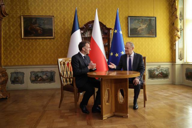 French President Emmanuel Macron (L) and Poland's Prime Minister Donald Tusk are pictuered during their meeting in the Golden Hall of the Uphagen House (Dom Uphagena) in Gdansk, Poland, on April 20, 2026, at the start of his one-day-visit to Poland. (Photo by Ludovic MARIN / AFP)