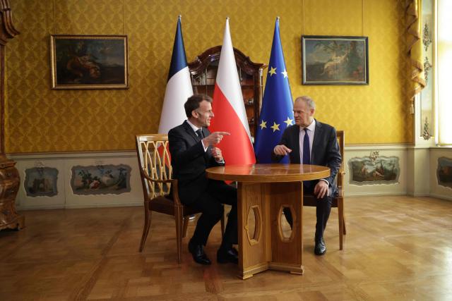 French President Emmanuel Macron (L) and Poland's Prime Minister Donald Tusk are pictuered during their meeting in the Golden Hall of the Uphagen House (Dom Uphagena) in Gdansk, Poland, on April 20, 2026, at the start of his one-day-visit to Poland. (Photo by Ludovic MARIN / AFP)