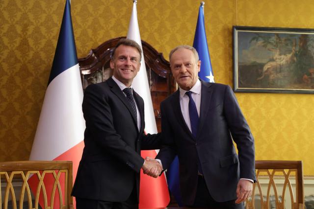 French President Emmanuel Macron (L) and Poland's Prime Minister Donald Tusk shake hands during their meeting in the Golden Hall of the Uphagen House (Dom Uphagena) in Gdansk, Poland, on April 20, 2026, at the start of his one-day-visit to Poland. (Photo by Ludovic MARIN / AFP)