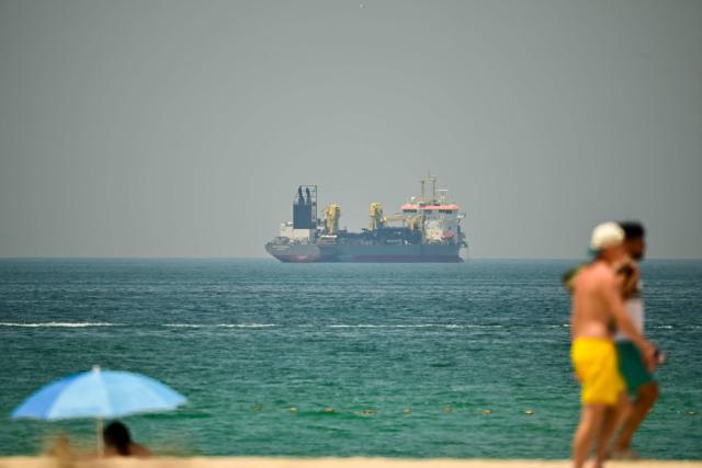 A commercial vessel is seen off the coast of Dubai on April 20, 2026. Oil prices jumped sharply on April 20 over fears hostilities could resume in the weeks-long war, after Iran closed the Strait of Hormuz again over the weekend following its brief reopening on Friday in recognition of a ceasefire in Lebanon. (Photo by AFP) / 