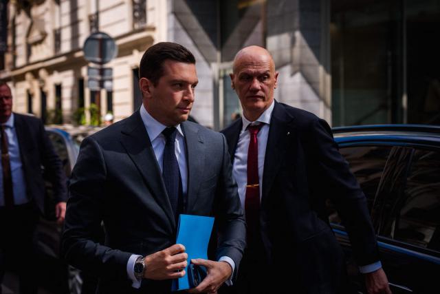 French far-right Rassemblement National RN party's President Jordan Bardella (C) arrives for a lunch meeting with French union Movement of the Enterprises of France (Medef) in Paris on April 20, 2026. (Photo by Dimitar DILKOFF / AFP)