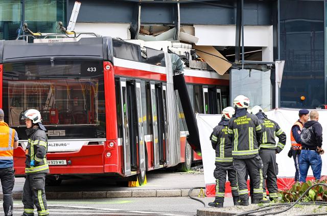 Firefighters and rescue personnel stand next to a trolleybus that crashed into a supermarket on April 20, 2026 in Salzburg, Austria, killing one person and injuring seven peaple, two of them severely. (Photo by various sources / AFP) / Austria OUT