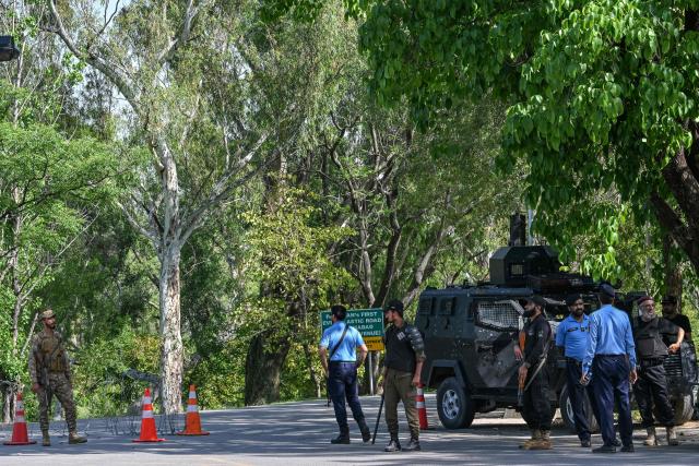 Security personnel stand guard at a checkpost near the Serena Hotel at the Red Zone area in Islamabad on April 20, 2026, amid heightened security measures ahead of anticipated US-Iran peace talks. Iran insisted it has no plan to attend a new round of negotiations with the United States on April 20, as uncertainty grows over a push to stop the Middle East war from resuming. (Photo by Asif HASSAN / AFP)