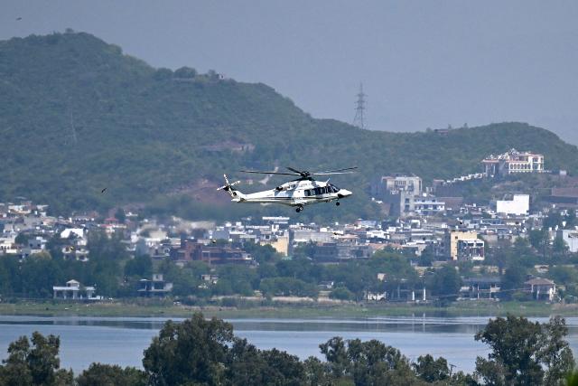 A helicopter flies over the Red Zone area in Islamabad on April 20, 2026, amid heightened security measures ahead of anticipated US-Iran peace talks. Iran is not currently planning to attend talks with the United States, state media said, after President Donald Trump ordered US negotiators to travel to Pakistan on April 20, just days before a ceasefire in the Middle East expires. (Photo by Aamir QURESHI / AFP)