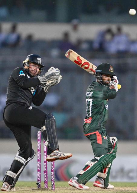 Bangladesh's Towhid Hridoy (R) plays a shot as New Zealand's wicketkeeper captain Tom Latham watches during the second one-day international (ODI) cricket match between Bangladesh and New Zealand at Sher-e-Bangla National Stadium in Mirpur on April 20, 2026. (Photo by Munir UZ ZAMAN / AFP)