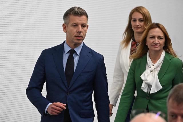 Election winner and leader of Hungary's TISZA party Peter Magyar (L) walks next to Agnes Forsthoffer (2nd R), vice-president of the TISZA party and designated speaker of Hungary's parliament, and Andrea Bujdoso (R) TISZA's designated parliamentary group leader, as they arrive for a press conference following the first official meeting of TISZA's new parliamentary group at the HUNGEXPO Congress and Exhibition Center in Budapest, Hungary, on April 20, 2026. Hungary's nationalist long-time Prime Minister Viktor Orban lost on April 12, 2026 to political newcomer, conservative pro-EU Peter Magyar, whose party won a two-thirds parliamentary majority in a vote marked by record turnout in the central European country. (Photo by Attila KISBENEDEK / AFP)