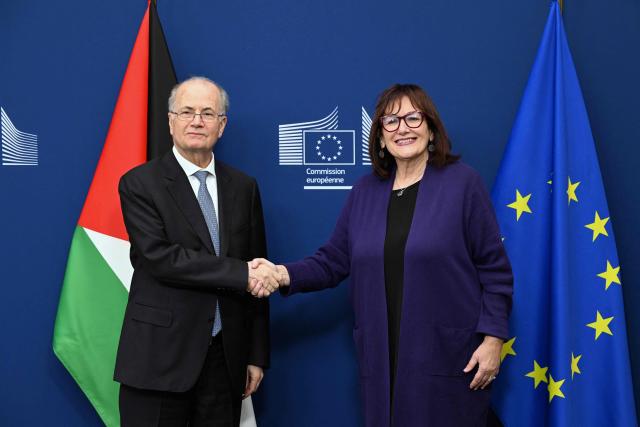 Palestinian Prime Minister Mohammad Mustafa (L) is welcomed by EU Commissioner for Mediterranean Dubravka Suica (R) before a Ad Hoc Liaison Committee (AHLC) Ministerial Meeting, in Brussels on April 20, 2026. European backers put on a show of support for the Palestinian Authority and the push for a two-state solution, as the US-Israeli war with Iran has dragged focus away from Gaza. (Photo by Nicolas TUCAT / AFP)