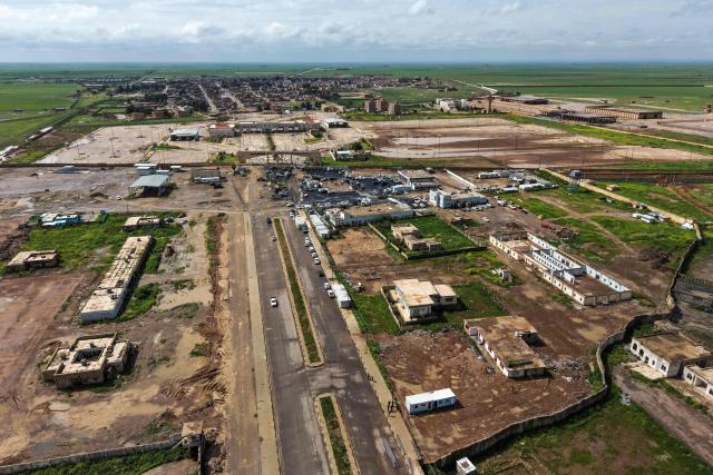 This aerial picture shows a view of the al-Rabia border crossing between Iraq and Syria on April 20, 2026. Iraq reopened a once-bustling border crossing with Syria on Monday, more than a decade after it was closed to trade following the rise of the Islamic State group. (Photo by Zaid AL-OBEIDI / AFP)