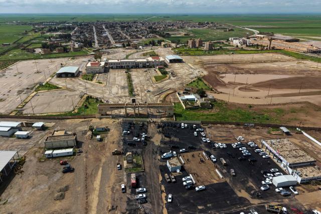 This aerial picture shows a view of the al-Rabia border crossing between Iraq and Syria on April 20, 2026. Iraq reopened a once-bustling border crossing with Syria on Monday, more than a decade after it was closed to trade following the rise of the Islamic State group. (Photo by Zaid AL-OBEIDI / AFP)