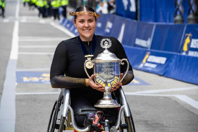 Eden Rainbow-Cooper of the UK holds the trophy after winning the women's wheelchair division during the 130th Boston Marathon on April 20, 2026, in Boston, Massachusetts. (Photo by Joseph Prezioso / AFP)