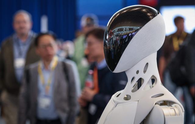 A humanoid robot is seen at the booth of Automotive supplier Schaeffler AG company during a tour of the Hannover industrial trade fair for mechanical and electrical engineering and digital industries, in Hannover, northern Germany on April 20, 2026. The fair opens its doors to the public on April 20 and will be running until April 24, 2026. (Photo by RONNY HARTMANN / AFP)