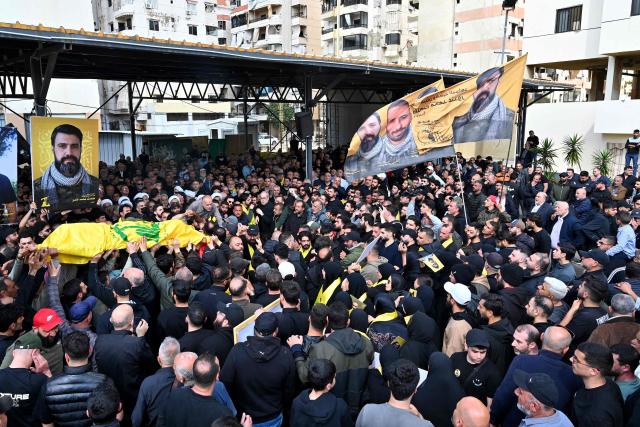 Mourners carry the flag-draped casket of a member of the Iran-backed militant group Hezbollah who was killed in southern Lebanon during their funeral in the Kafaat area in Beirut's southern suburbs on April 20, 2026. Hezbollah lawmaker Hassan Fadlallah said on April 20 that his group would work to break the "Yellow Line" that Israel established in southern Lebanon, adding that no one could disarm the Iran-backed group. Lebanon was drawn into the Middle East war on March 2 when Tehran-backed militant group Hezbollah launched attacks on Israel to avenge the killing of the Iranian leader. Israel has responded with broad strikes across Lebanon and a ground offensive. (Photo by FADEL itani / AFP)