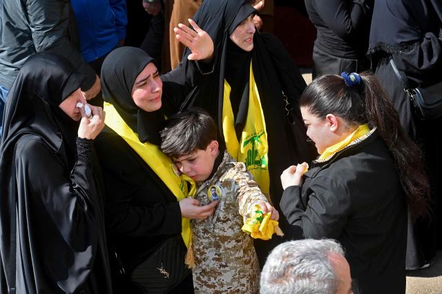 Friends and relatives mourn during the funeral of four members of the Iran-backed militant group Hezbollah who were killed in southern Lebanon, in the Kafaat area in Beirut's southern suburbs on April 20, 2026. Hezbollah lawmaker Hassan Fadlallah said on April 20 that his group would work to break the "Yellow Line" that Israel established in southern Lebanon, adding that no one could disarm the Iran-backed group. Lebanon was drawn into the Middle East war on March 2 when Tehran-backed militant group Hezbollah launched attacks on Israel to avenge the killing of the Iranian leader. Israel has responded with broad strikes across Lebanon and a ground offensive. (Photo by FADEL itani / AFP)
