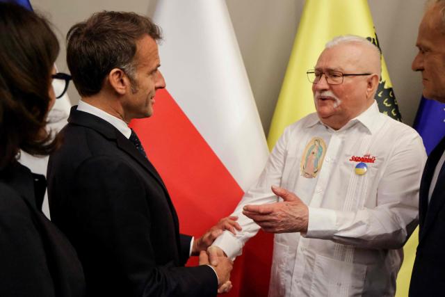 (LtoR) Mayor of Gdansk Aleksandra Dulkiewicz, French President Emmanuel Macron, former President of Poland Lech Walesa and Polish Prime Minister Donald Tusk meet at the European Solidarity Centre in Gdansk, Poland, on April 20, 2026 during the French President's one-day visit to Poland. (Photo by Ludovic MARIN / AFP)
