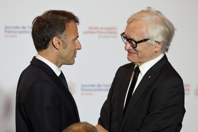 French President Emmanuel Macron (L) congratulates Bronislaw Geremek Award laureate and Polish actor and director Andrzej Seweryn during the ceremony for the presentation of the Bronislaw Geremek Award at the European Solidarity Centre in Gdansk, Poland, on April 20, 2026 during the French President's one-day visit to Poland. (Photo by Ludovic MARIN / AFP)