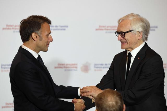 French President Emmanuel Macron (L) congratulates Bronislaw Geremek Award laureate and Polish actor and director Andrzej Seweryn during the ceremony for the presentation of the Bronislaw Geremek Award at the European Solidarity Centre in Gdansk, Poland, on April 20, 2026 during the French President's one-day visit to Poland. (Photo by Ludovic MARIN / AFP)