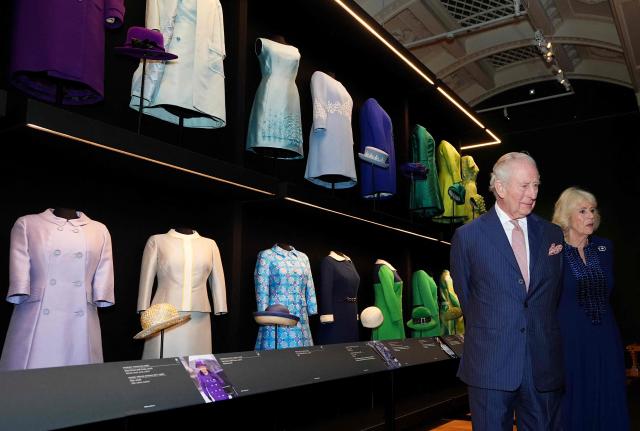 Britain's King Charles III and Britain's Queen Camilla view exhibits including outfits worn by his late mother Queen Elizabeth II, in the new Royal Collection Trust exhibition: Queen Elizabeth II: Her Life in Style, in The King's Gallery at Buckingham Palace in London on April 20, 2026. The exhibition is the largest and most comprehensive presentation of The late Queen’s fashion ever mounted. (Photo by Aaron Chown / POOL / AFP)