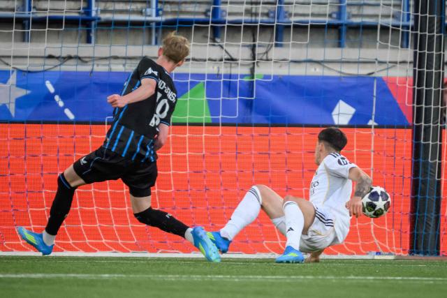 Club Brugge's Danish midfielder #78 Tobias Lund Jensen scores his team's first goal during the UEFA Youth League final football match between Club Brugge and Real Madrid at Stade de la Tuiliere in Lausanne, on April 20, 2026. (Photo by Fabrice COFFRINI / AFP)