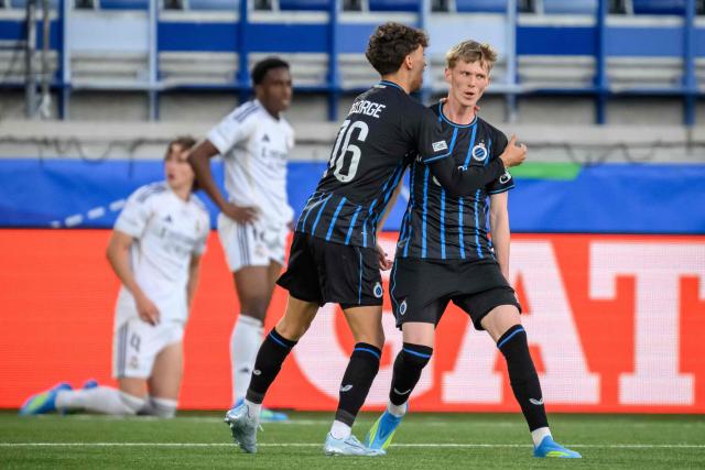 Club Brugge's Danish midfielder #78 Tobias Lund Jensen (R) is congratulated after  scoring his team's first goal during the UEFA Youth League final football match between Club Brugge and Real Madrid at Stade de la Tuiliere in Lausanne, on April 20, 2026. (Photo by Fabrice COFFRINI / AFP)
