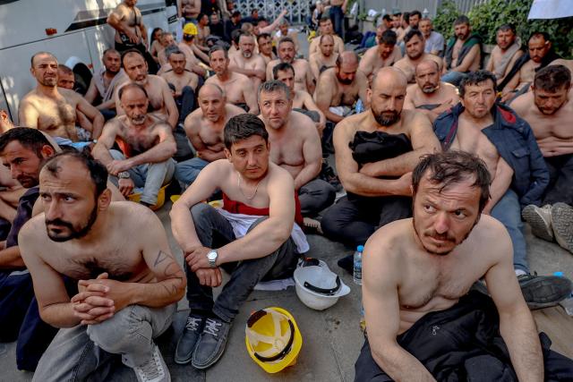Around 90 miners stage topless a sit-in protest outside Turkey's Energy Ministry to demand unpaid wages in Ankara, on April 20, 2026. Hundreds of workers from Doruk Mining, members of the Independent Miners' Union, walked a 180-kilometre way in nine days to reach Ankara, calling on authorities to address what they described as months of delayed payments and unresolved compensation claims. (Photo by Adem ALTAN / AFP)