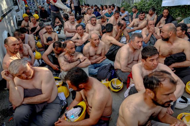 Around 90 miners stage topless a sit-in protest outside Turkey's Energy Ministry to demand unpaid wages in Ankara, on April 20, 2026. Hundreds of workers from Doruk Mining, members of the Independent Miners' Union, walked a 180-kilometre way in nine days to reach Ankara, calling on authorities to address what they described as months of delayed payments and unresolved compensation claims. (Photo by Adem ALTAN / AFP)