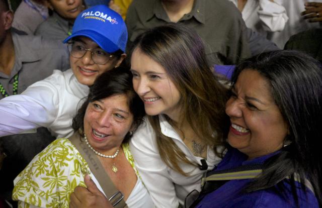 Colombia's right-wing presidential candidate Paloma Valencia, of the Centro Democratico party, poses for pictures with supporters during a campaign rally in Cali, Valle del Cauca department, Colombia on April 20, 2026. Colombia will hold a presidential election on May 31, 2026. (Photo by JOAQUIN SARMIENTO / AFP)